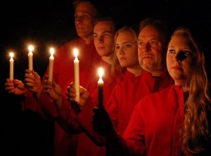 Five singers holding candles