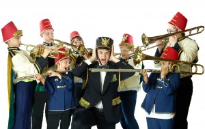 Professor Harold Hill surrounded by young boys in band uniforms