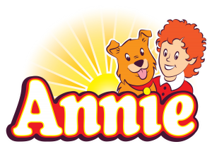 The characters of Annie and Sandy the dog appear in front of a sunrise